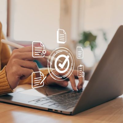 Hand of young woman holding a pen pointing to document and mark correct sign. CyberEssentials Principles checks all the cyber security awareness boxes for an exception training program.