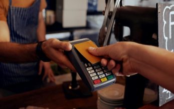 person paying with credit card tap representing pci dss training