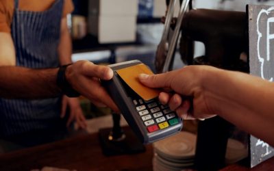 person paying with credit card tap representing pci dss training